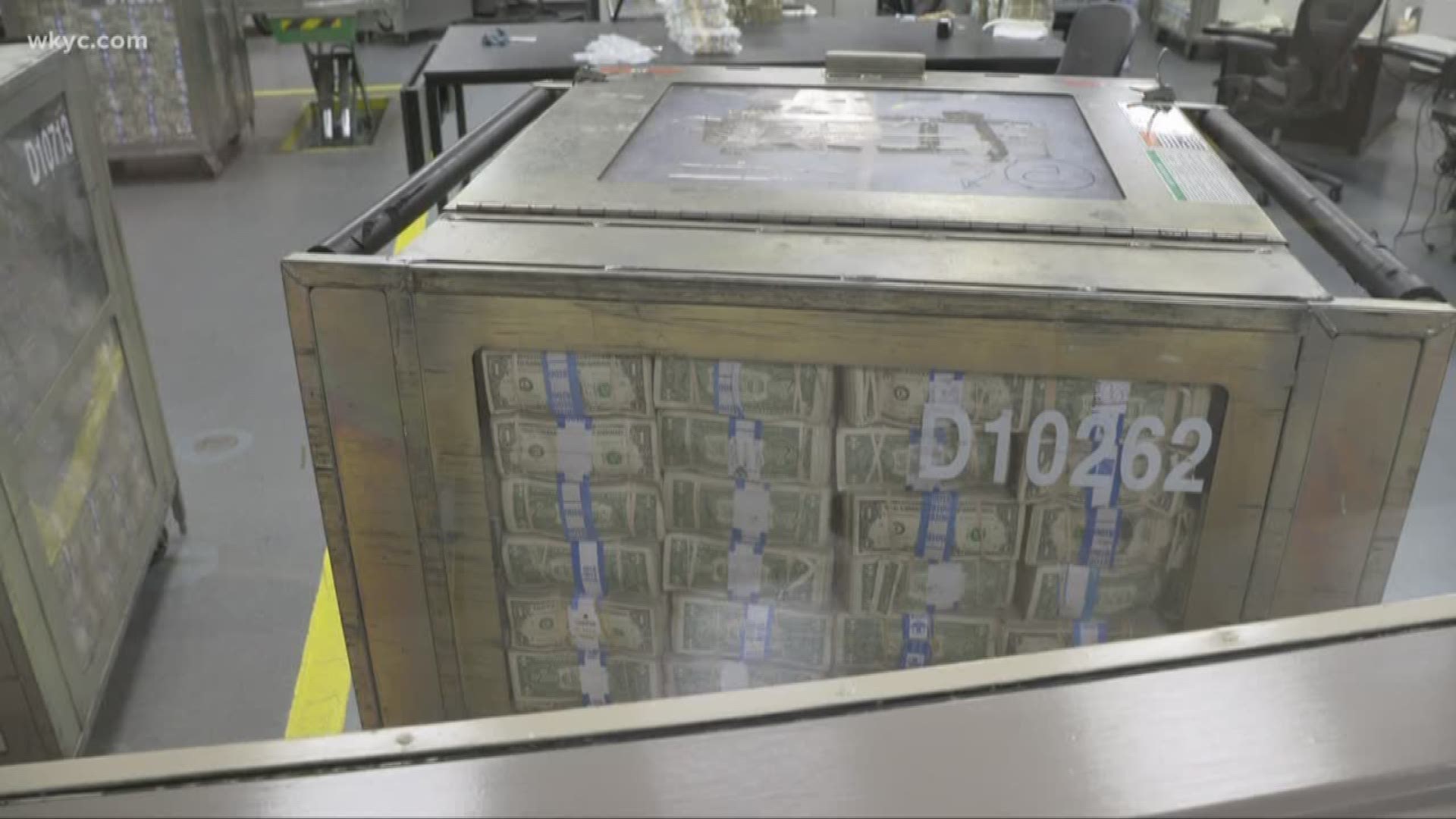 US dollar bills and coins in a secure vault