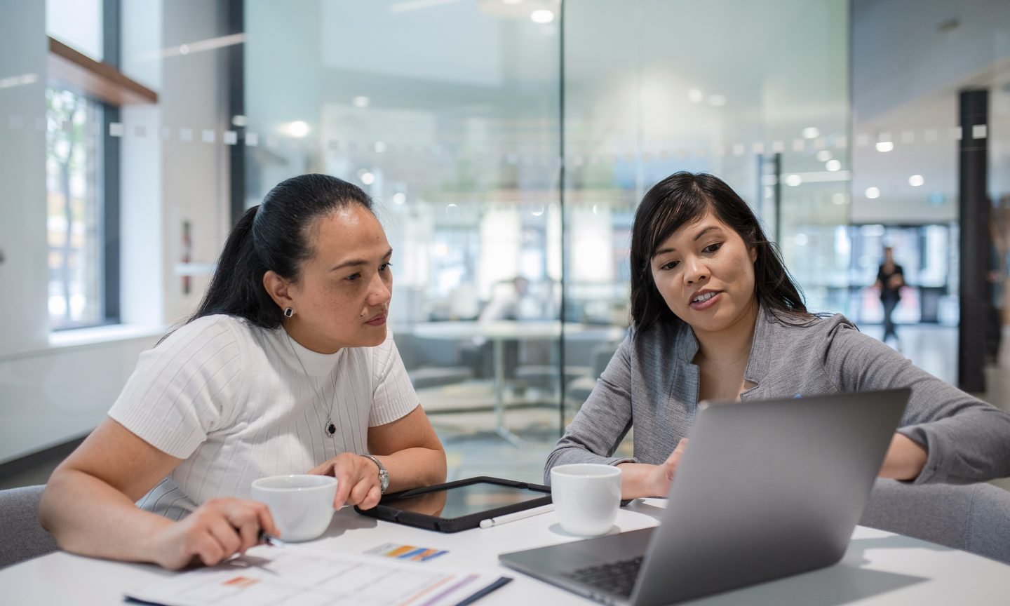 Business team reviewing documents together while opening a crypto bank account