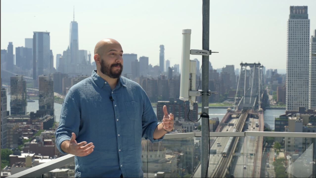 Cityscape featuring multiple Dawn Internet rooftop antennas on residential buildings, showcasing their compact design and seamless urban integration for decentralized broadband networks.