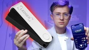 Close-up of Ledger Nano S Plus hardware wallet next to a smartphone displaying the Electron Cash Bitcoin Cash wallet app