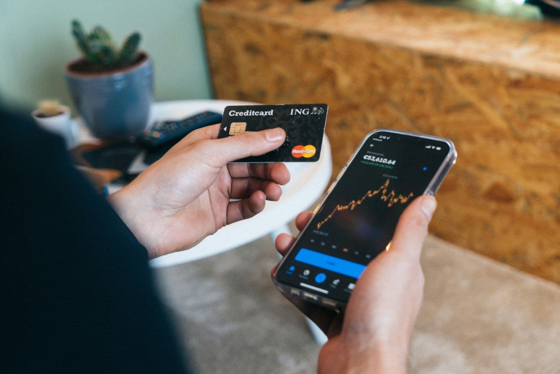 Close-up of a modern stablecoin payment card beside a smartphone displaying a crypto wallet app, illustrating anonymous crypto off-ramping.