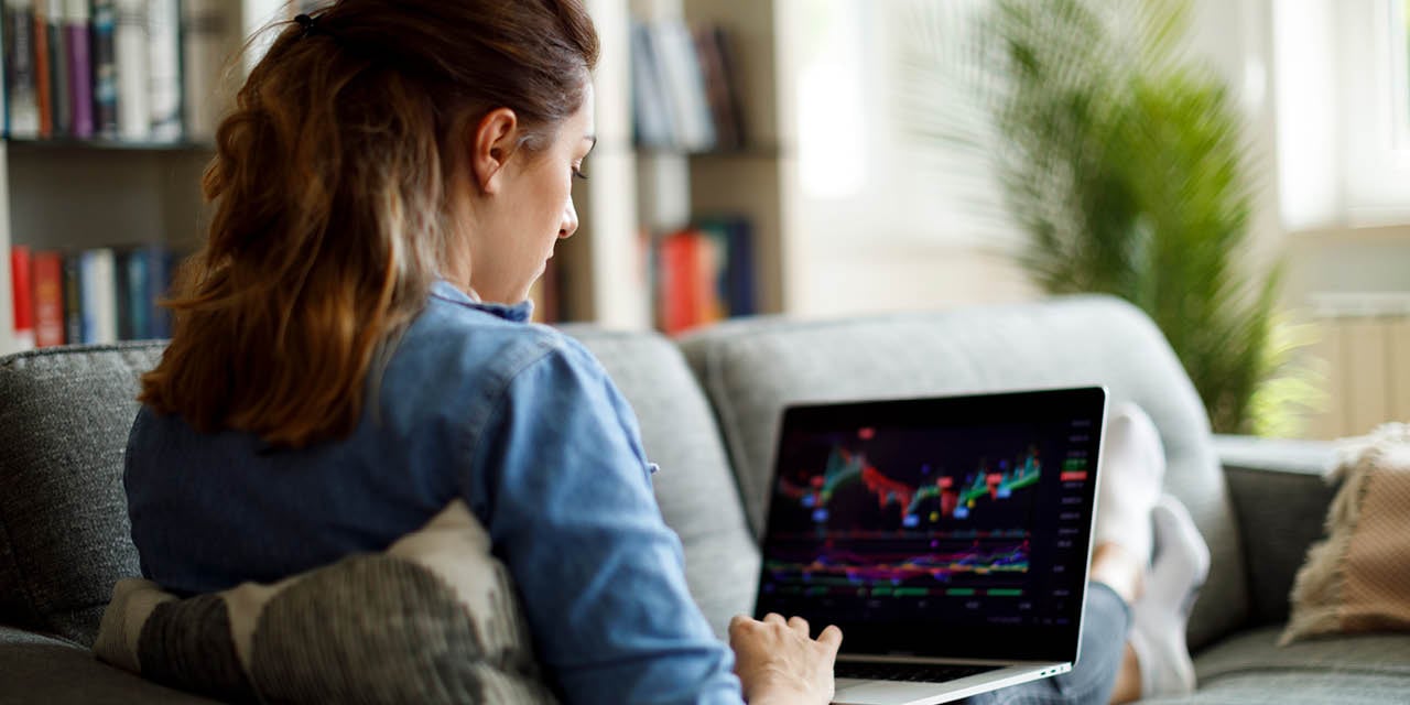 Diverse American employees using laptops and tablets to review digital 401(k) retirement options including cryptocurrency investments