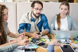 Diverse group of people using laptops and smartphones to learn about crypto, representing education, onboarding tools, community support, partnerships, and incentive programs for mass adoption.