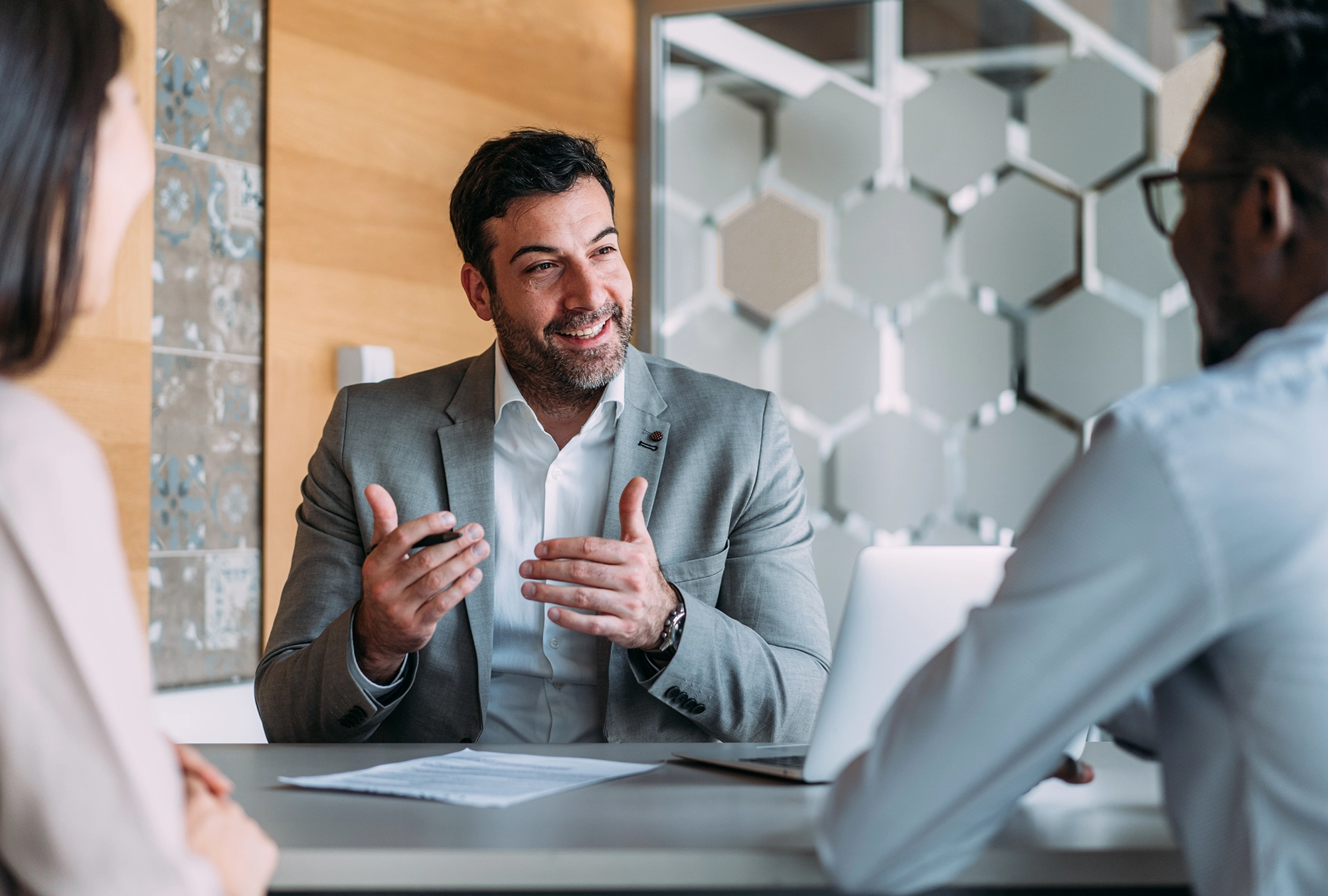 Diverse group of professionals discussing 401(k) crypto investment options in a modern office setting