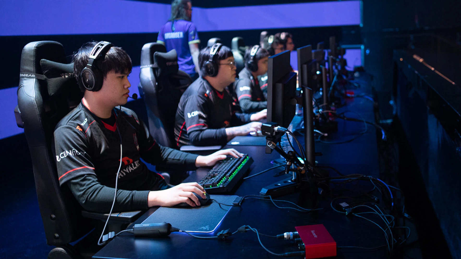 Beginner esports bettor holding a smartphone with crypto wallet icons and popular esports game graphics in the background, illustrating step-by-step crypto esports betting process