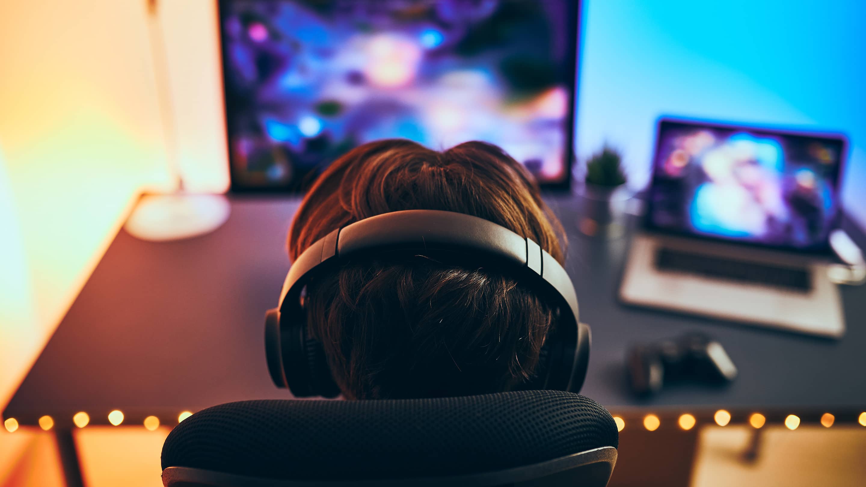 Gamer placing an esports bet with Bitcoin on a laptop, live match graphics in background