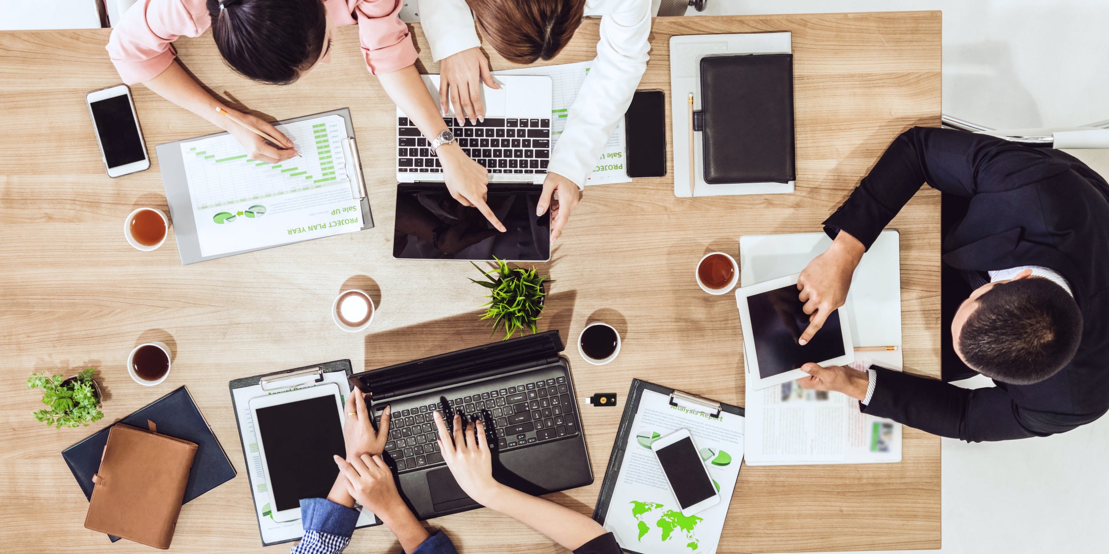Modern office team collaborating on laptops to open a crypto business account, focusing on compliance, documentation, and digital security steps in 2024.