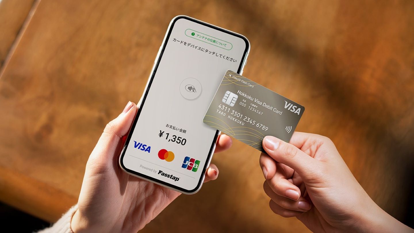 Person using a stablecoin card for contactless payment at a coffee shop in 2024