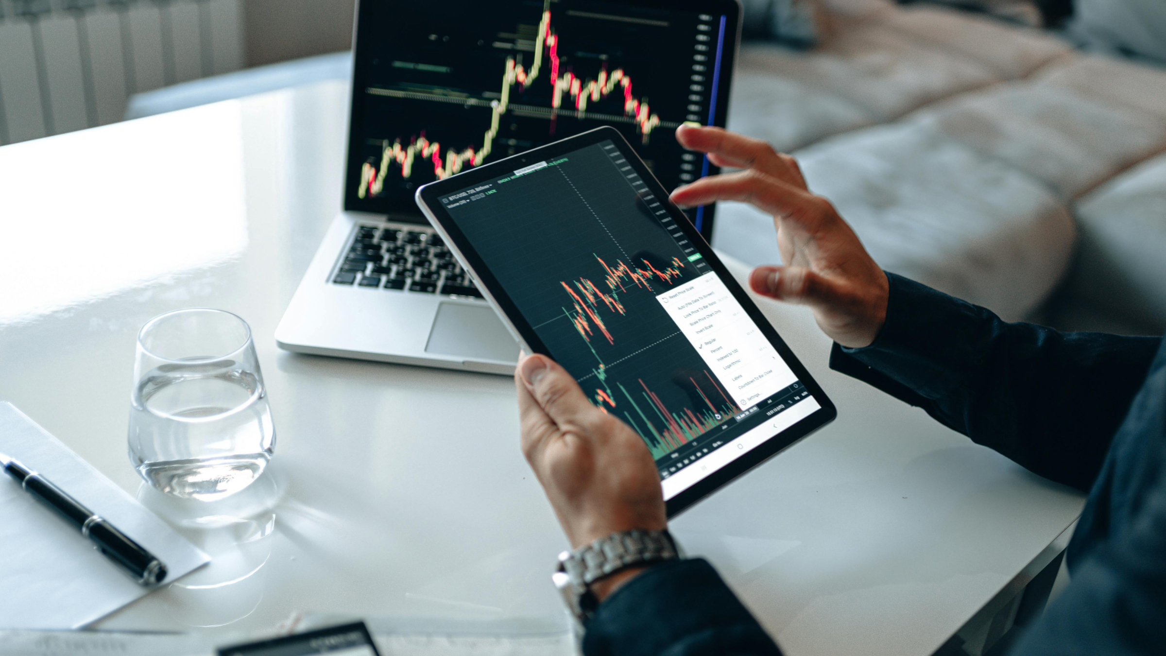 Person reviewing 401(k) investment options on a laptop with a digital Bitcoin symbol and investment dashboard visible, representing modern retirement planning with cryptocurrency.