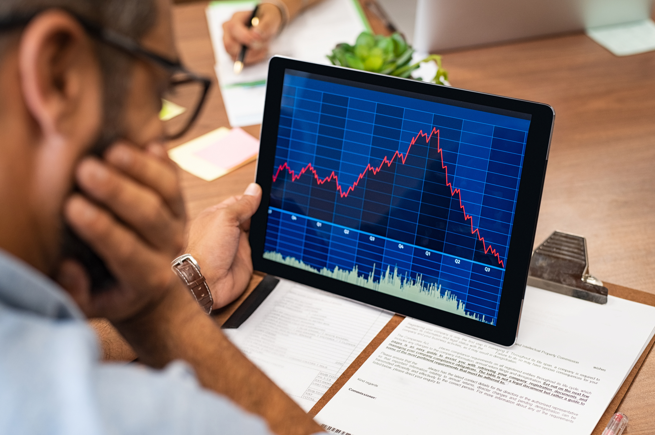 Person reviewing 401(k) statement on laptop with Bitcoin and traditional investment charts visible, representing crypto retirement planning in 2035