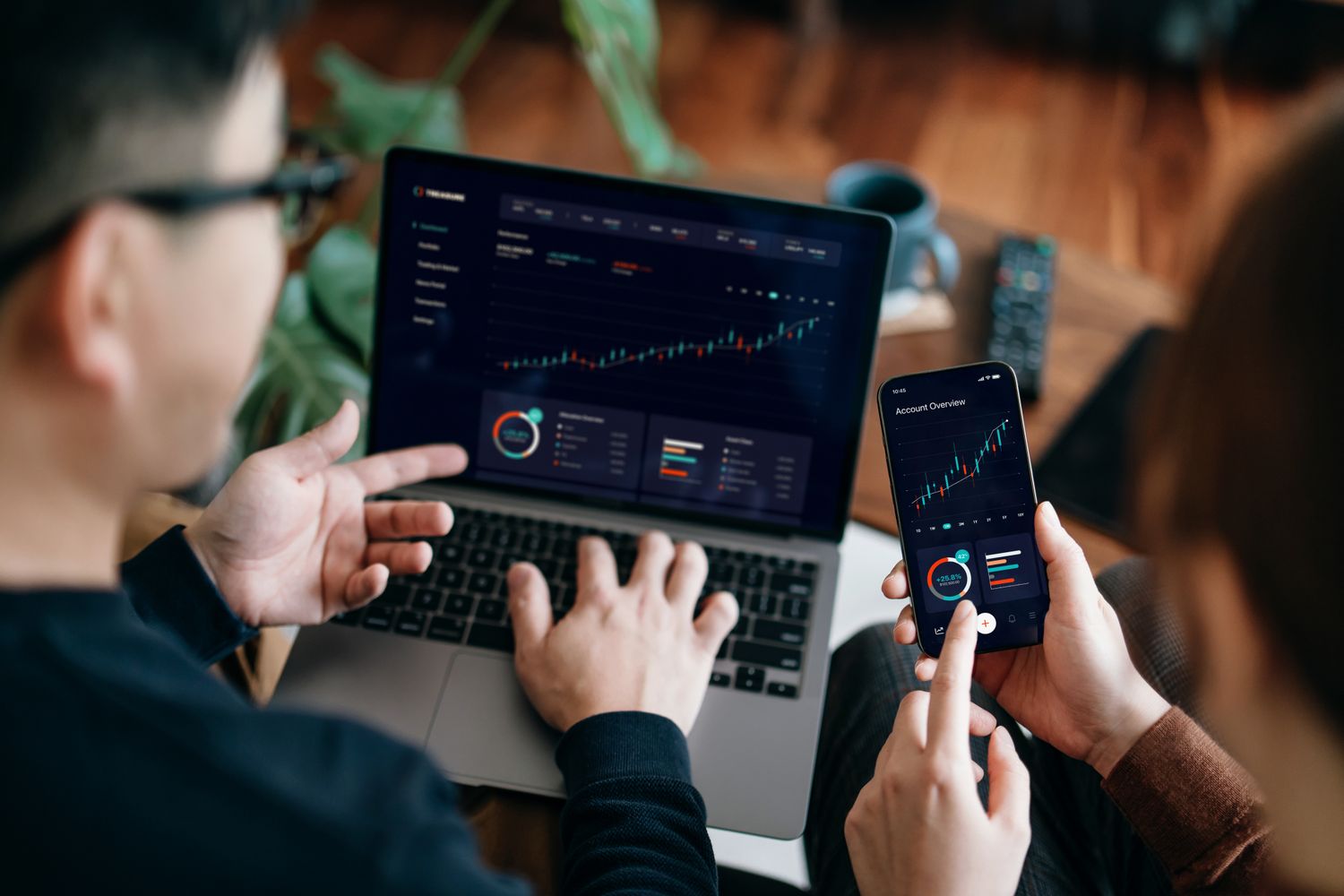 Person analyzing crypto retirement portfolio on laptop with digital financial charts in the background, representing Bitcoin 401k planning