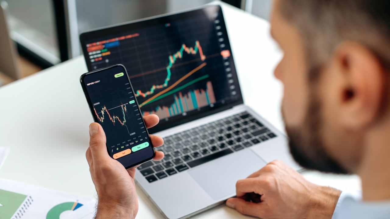 Person reviewing a diversified 401(k) portfolio on a laptop showing both cryptocurrency and traditional assets, representing modern retirement planning in 2025.
