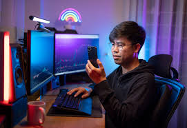Person using a smartphone to set up automated cryptocurrency purchases with a crypto exchange app interface visible