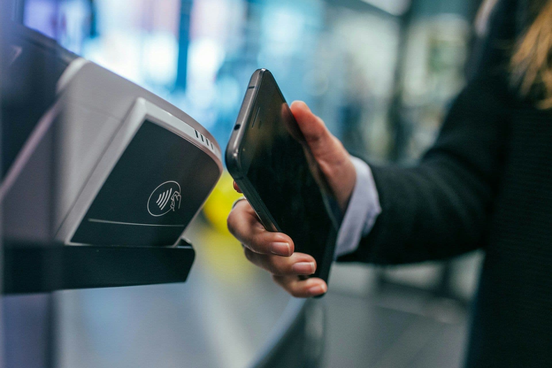 Modern crypto debit card with Apple Pay integration being used at a retail checkout terminal, illustrating seamless cryptocurrency payments for everyday purchases in 2025.