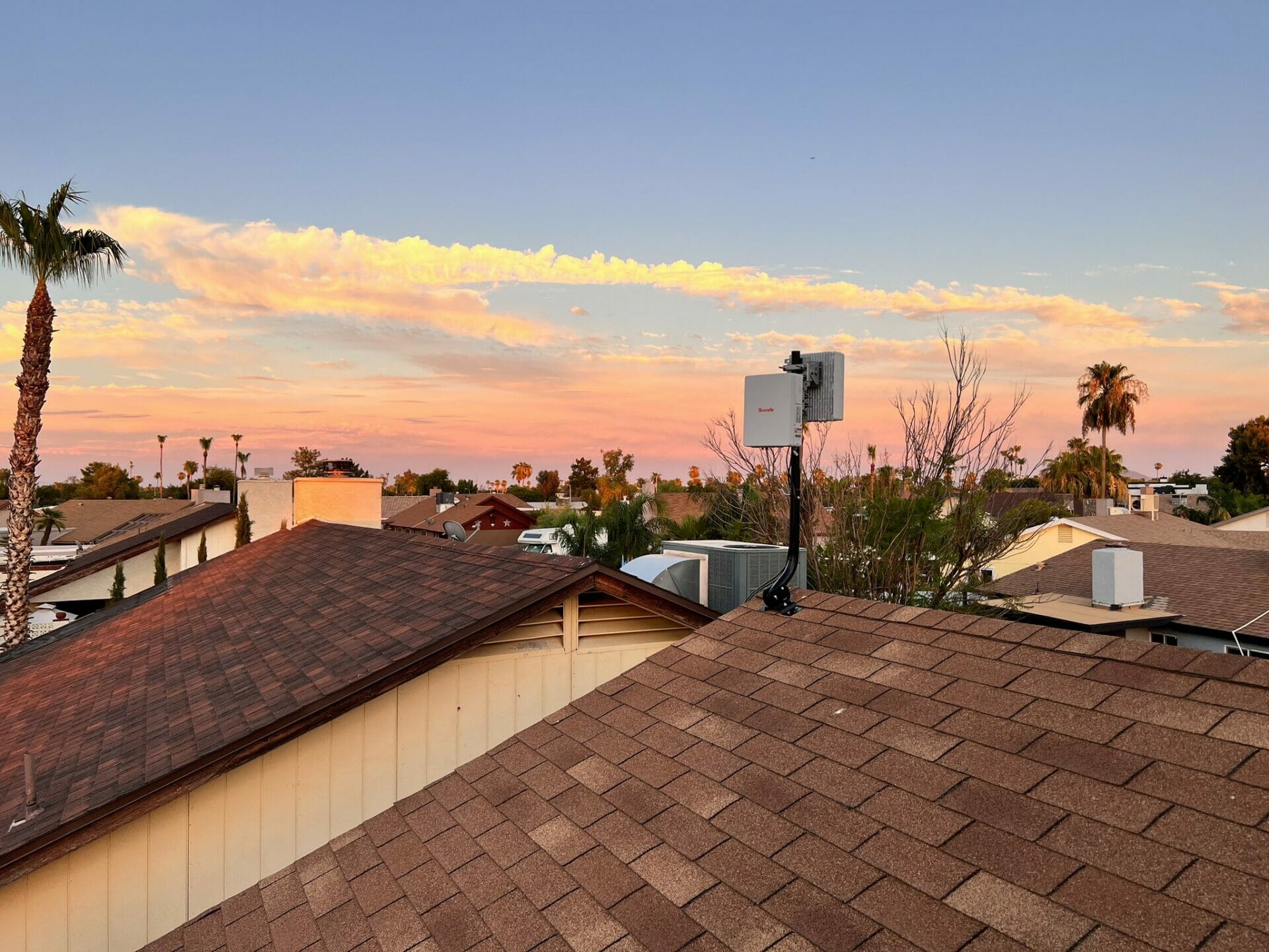 Rooftop Helium 5G hotspot installation in a modern urban city environment, showcasing community-owned wireless network infrastructure.