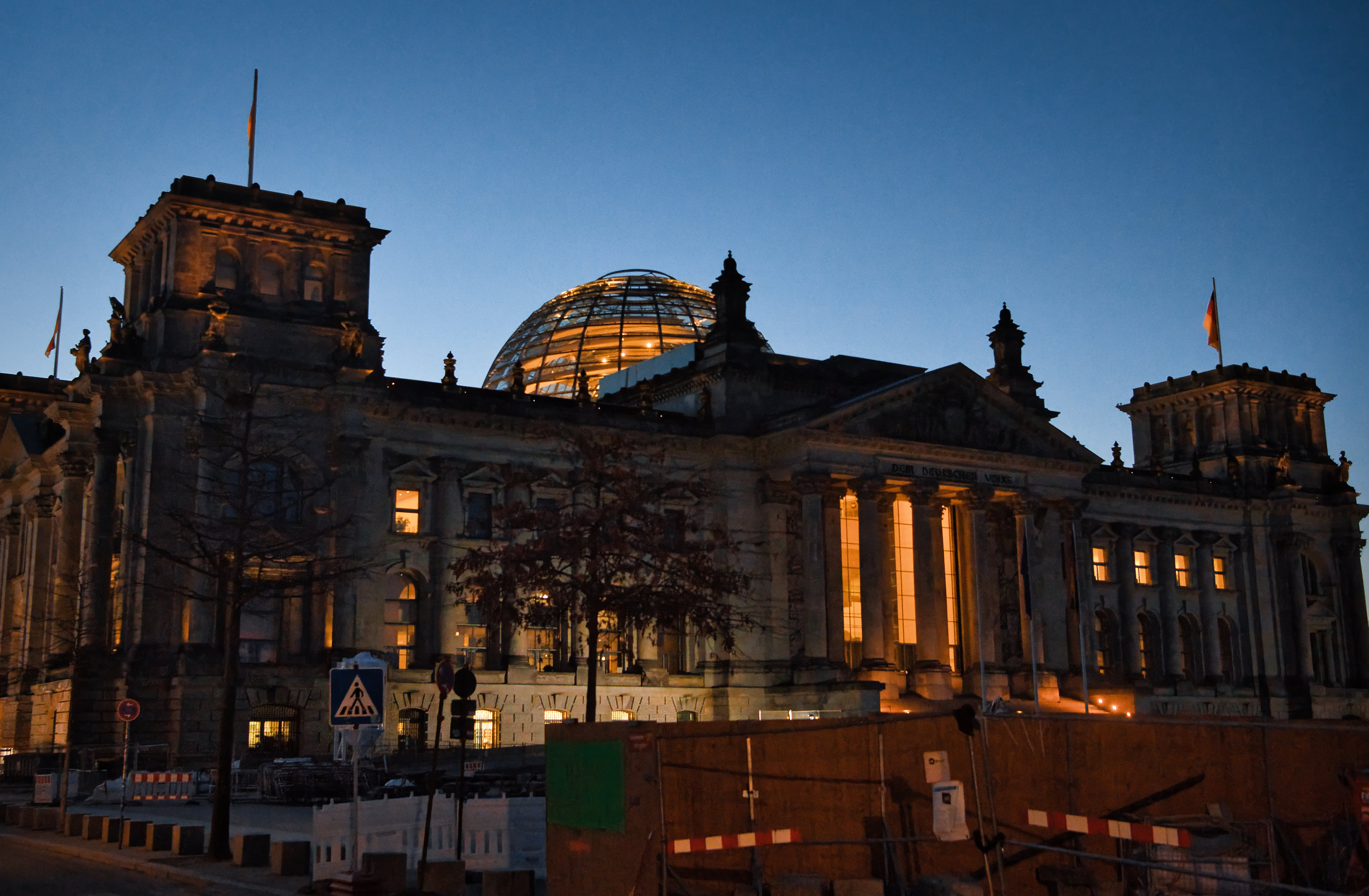 Berlin Reichstag building illuminated at dusk with a Bitcoin symbol projected onto its facade, symbolizing Germany's pro-Bitcoin policy shift