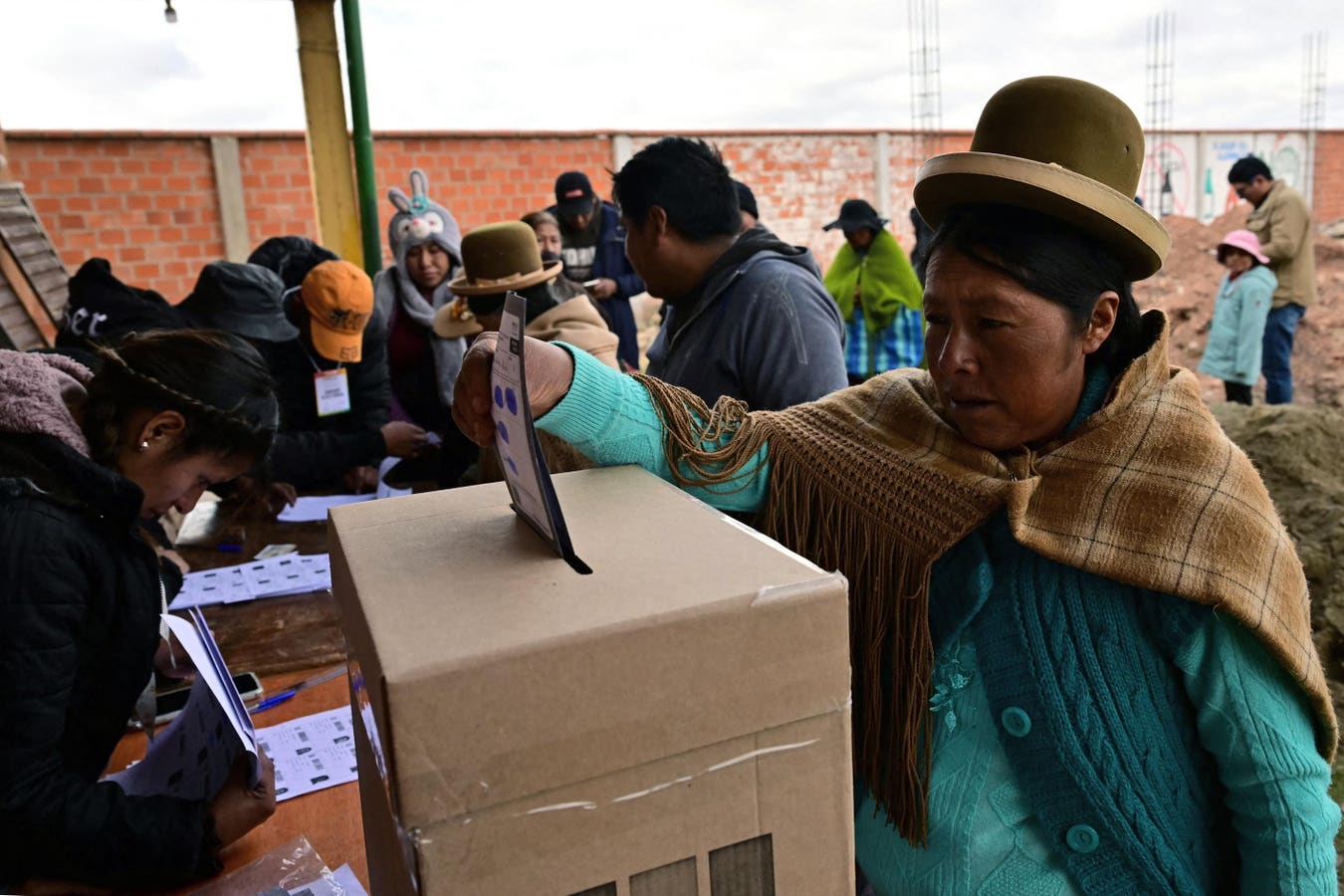 Bolivian election officials photographing paper ballot tallies for upload to Solana blockchain during 2025 presidential election