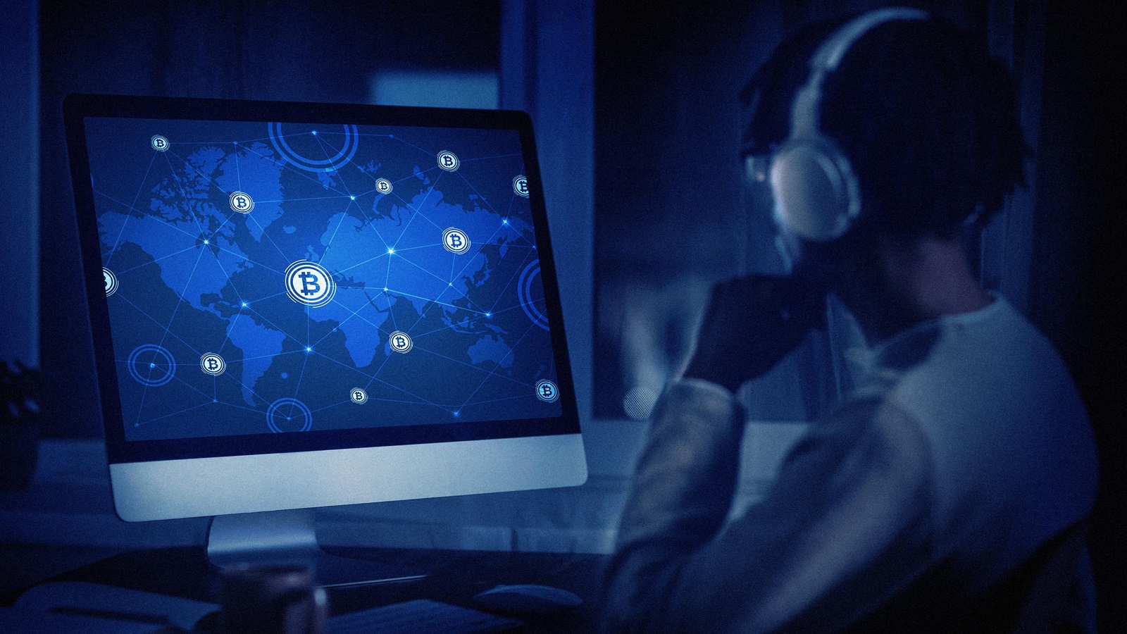 Professional team reviewing crypto banking documents on laptops in a modern office setting