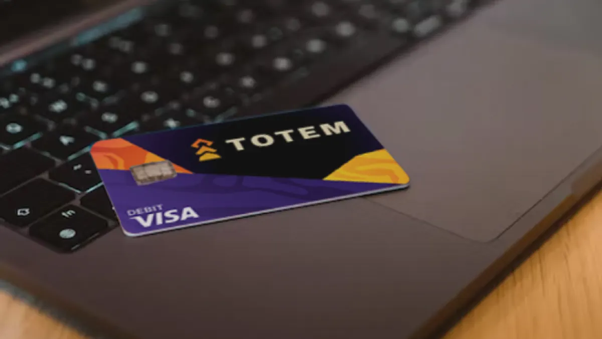Sleek Gnosis Pay Visa card resting on a laptop keyboard, representing digital crypto payments