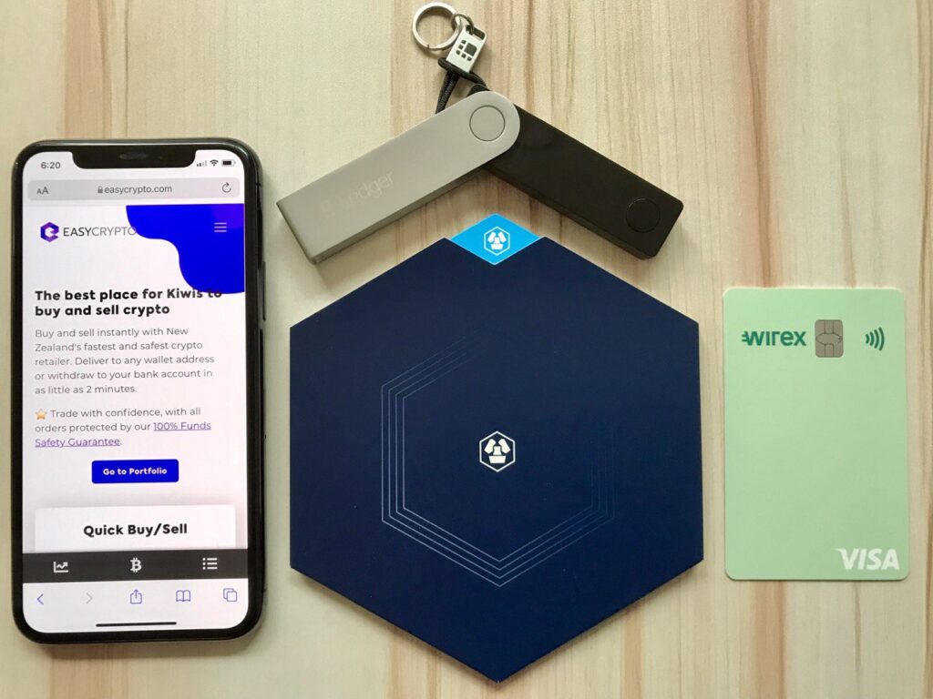 Sleek crypto rewards cards (Crypto.com Visa, Monolith, Coinbase Card) displayed on a hardware wallet with a smartphone app showing governance token balances (CRO, MKR, COMP, UNI, AAVE) in 2024