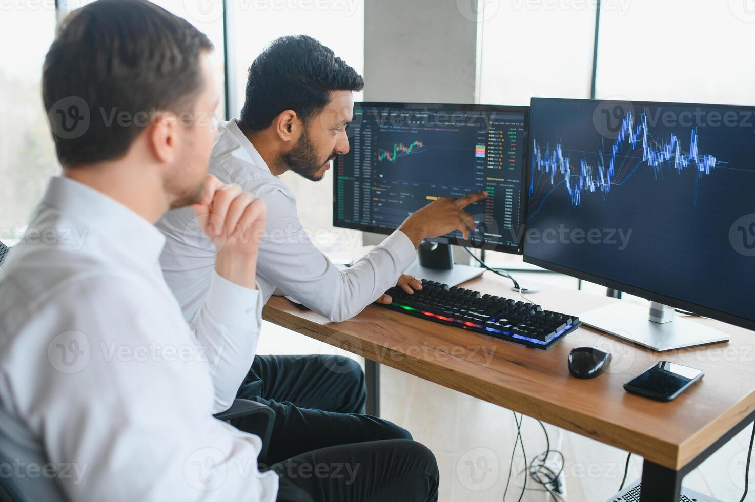 Thoughtful investor at a modern trading desk analyzing Bitcoin market trends on multiple computer screens, representing strategic decision-making during a crypto price dip.