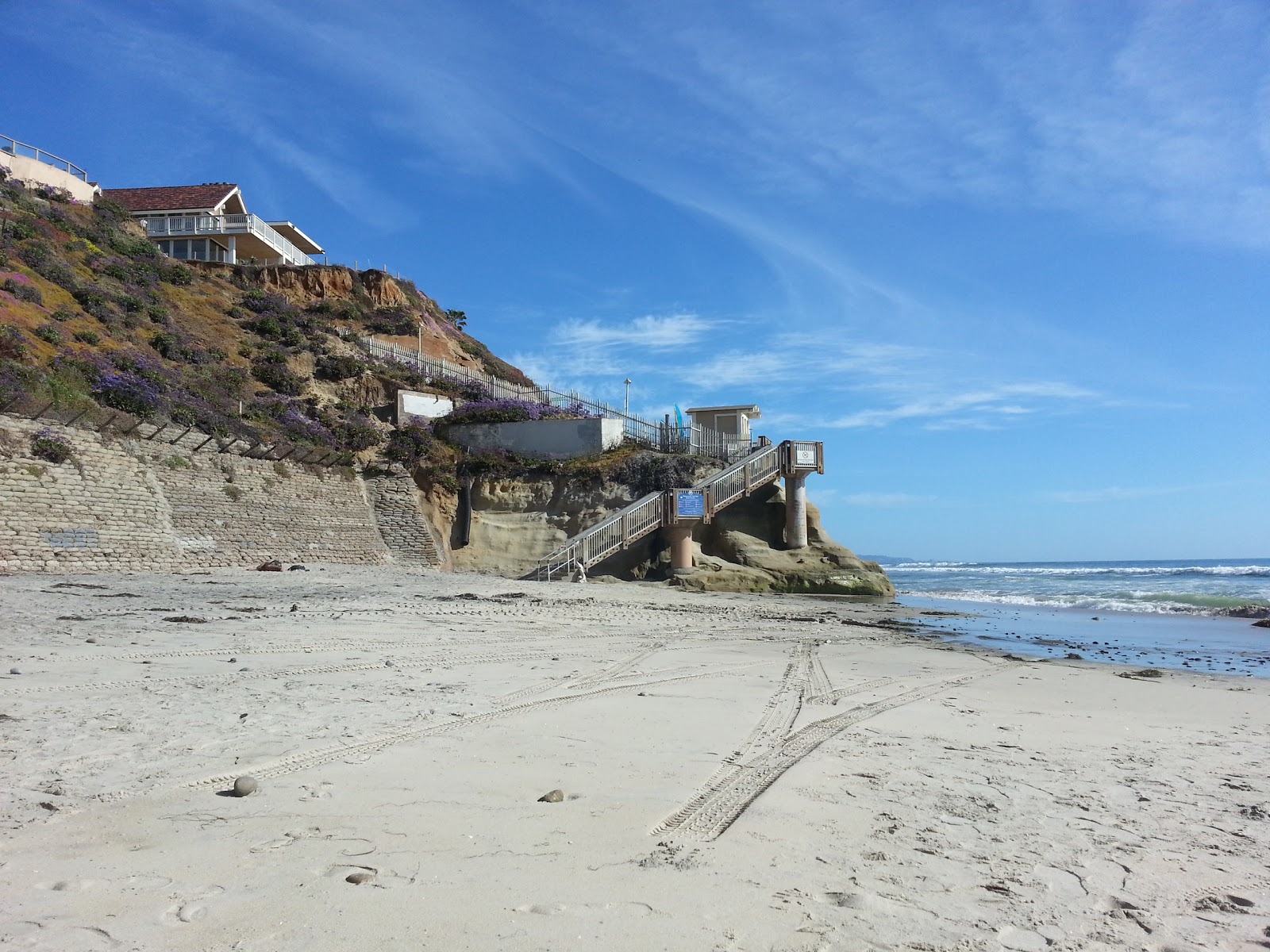 Vibrant beach scene with golden sand, blue ocean, and three golden Solana logos shimmering under a clear sky