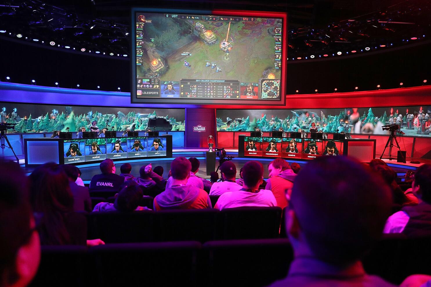 Vibrant esports arena with cheering fans and digital banners displaying cryptocurrency logos, highlighting the integration of crypto in esports betting communities in 2024.