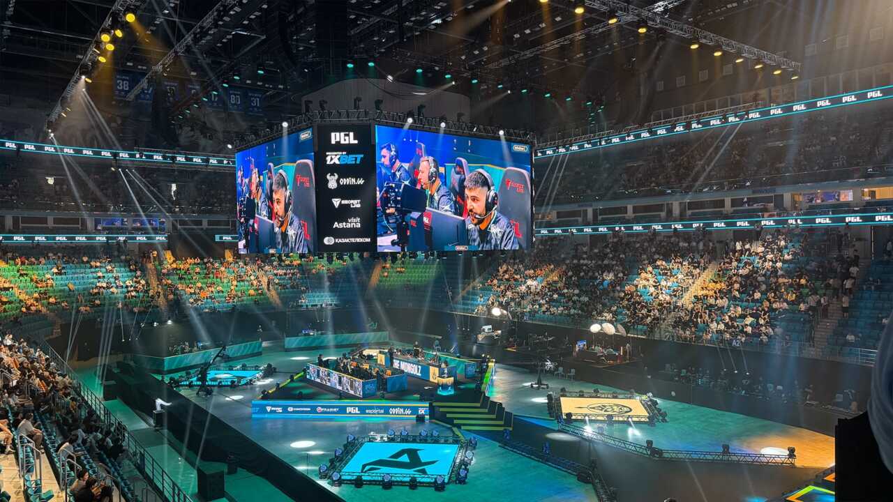 Vibrant esports arena packed with fans watching CS2 and Dota 2 matches on giant screens, showcasing the excitement of live esports events.