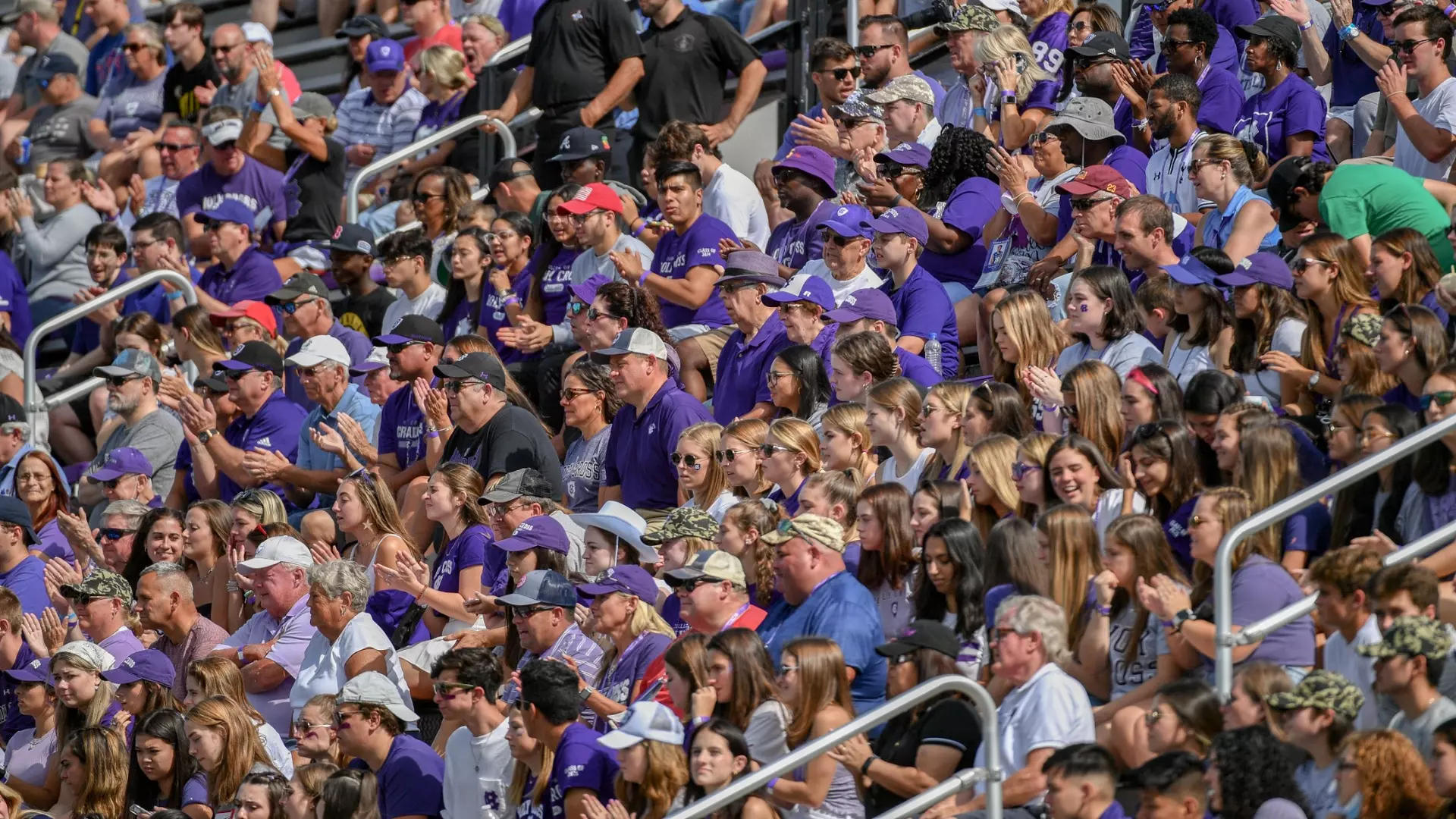 Soccer fans celebrating in a stadium while holding smartphones and displaying digital wallets, representing the excitement of buying fan tokens in 2025.