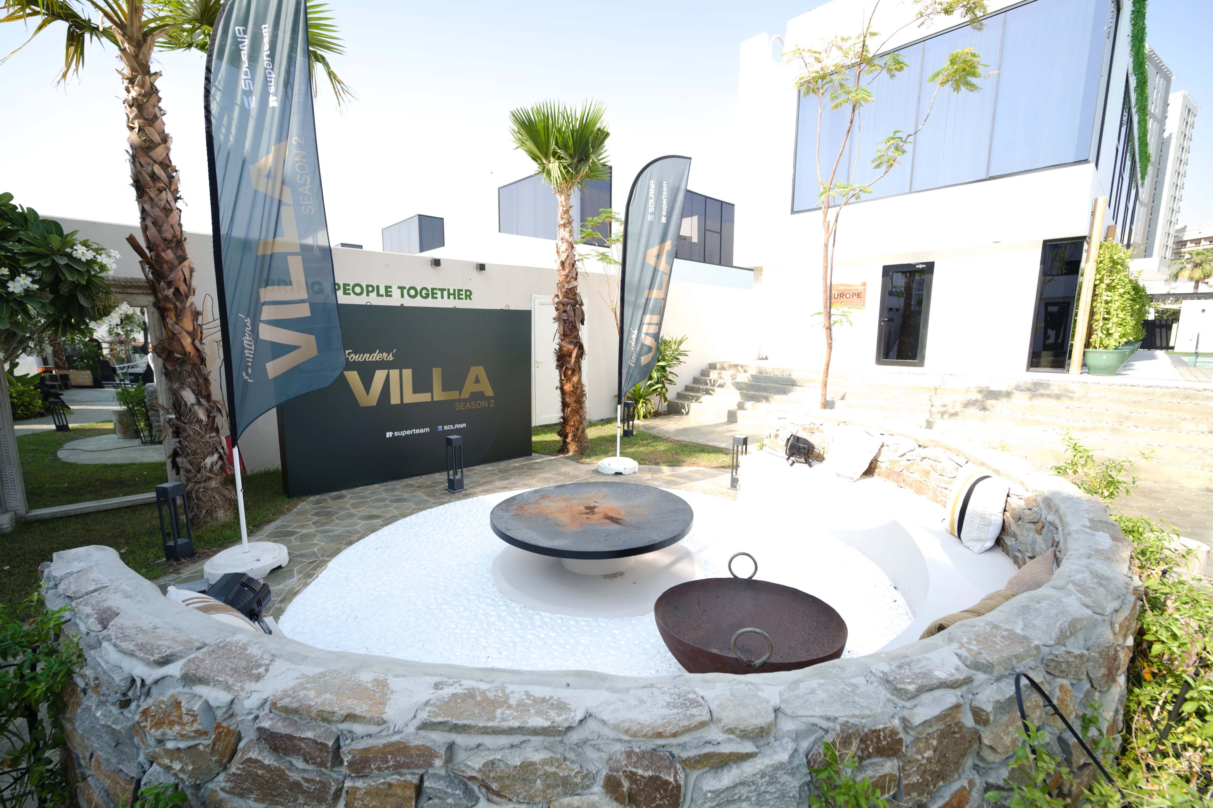 10 women discussing crypto strategies poolside at a modern villa during Solana Summer Society reality show