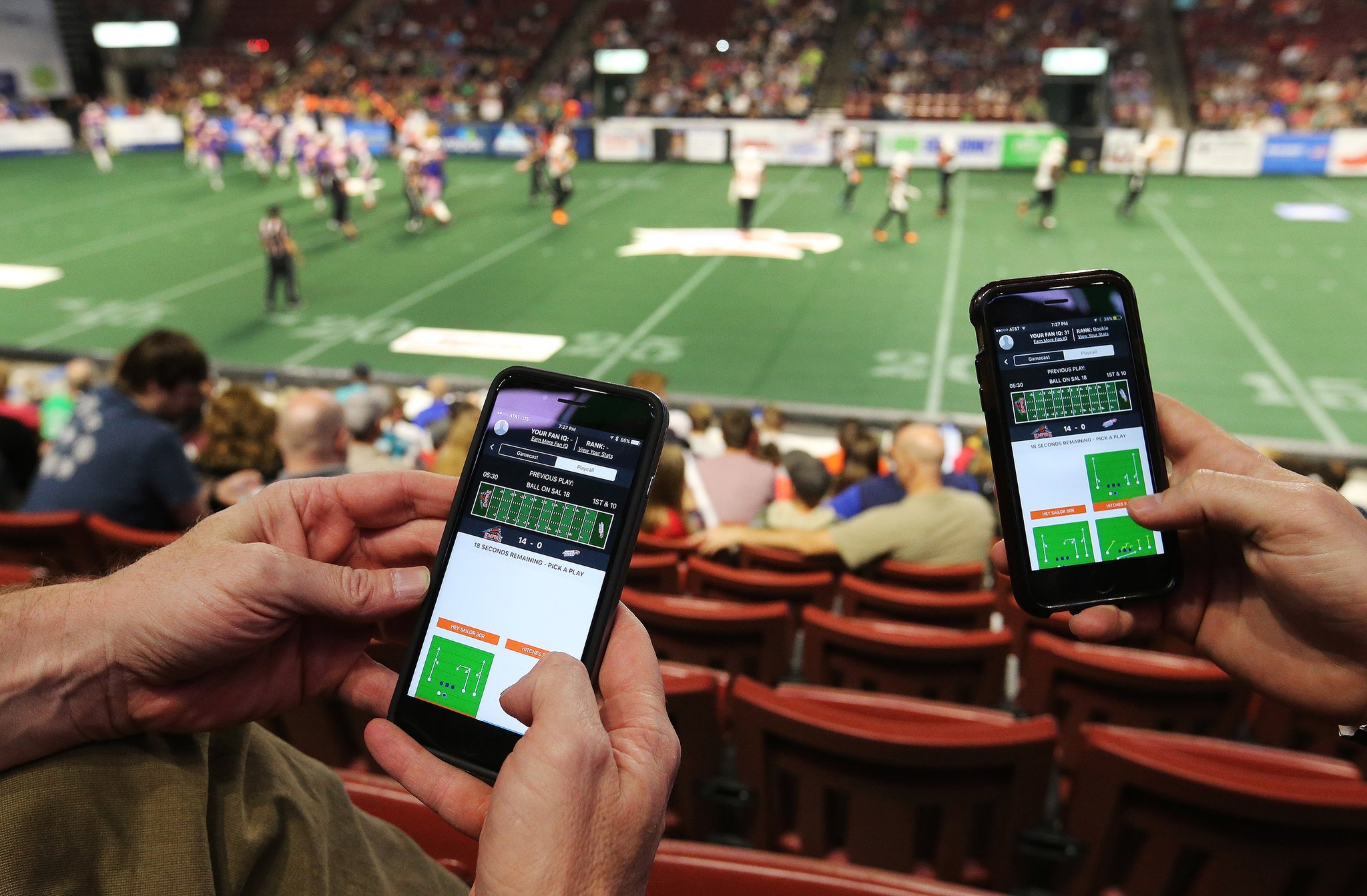Soccer fans in a stadium trading fan tokens on their smartphones, capturing the excitement of digital engagement with favorite teams.