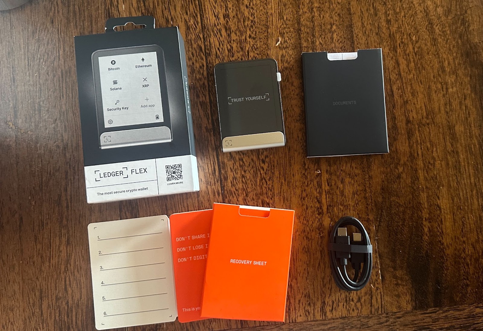 Ledger Flex Solana Edition hardware wallet next to Binance Wallet app interface, showcasing a side-by-side comparison for 2025 crypto users