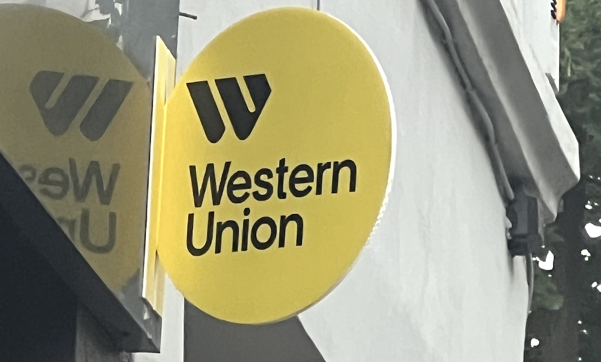 User sending international remittance using stablecoin on a mobile phone, illustrating Western Union's crypto integration