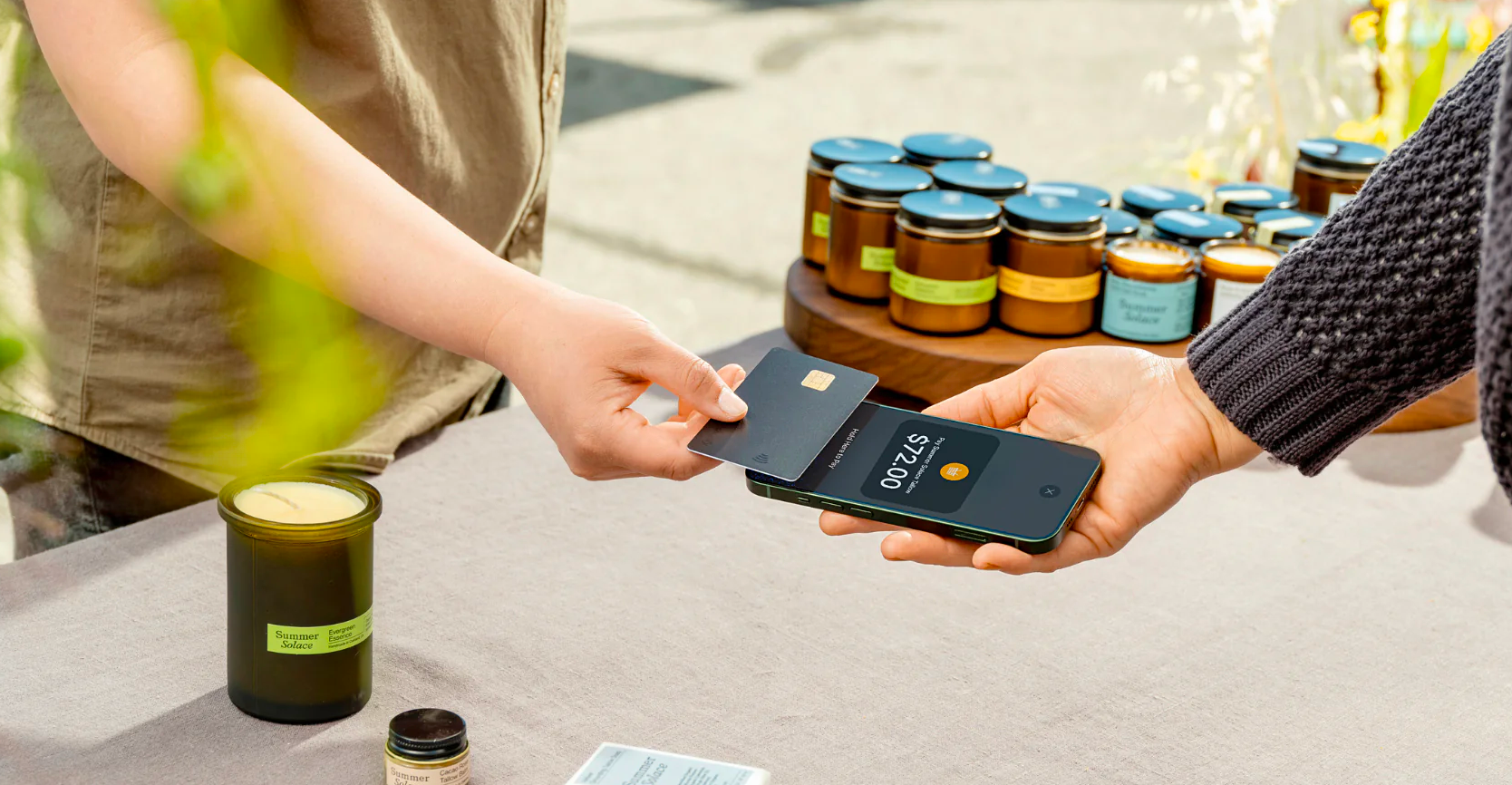 person tapping phone to pay at event terminal