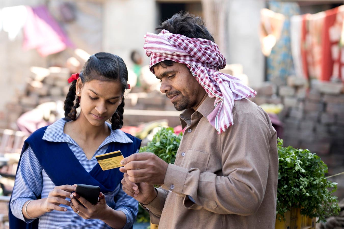 People using smartphones at a digital bank branch in a rural underbanked region, showcasing DeFi financial inclusion