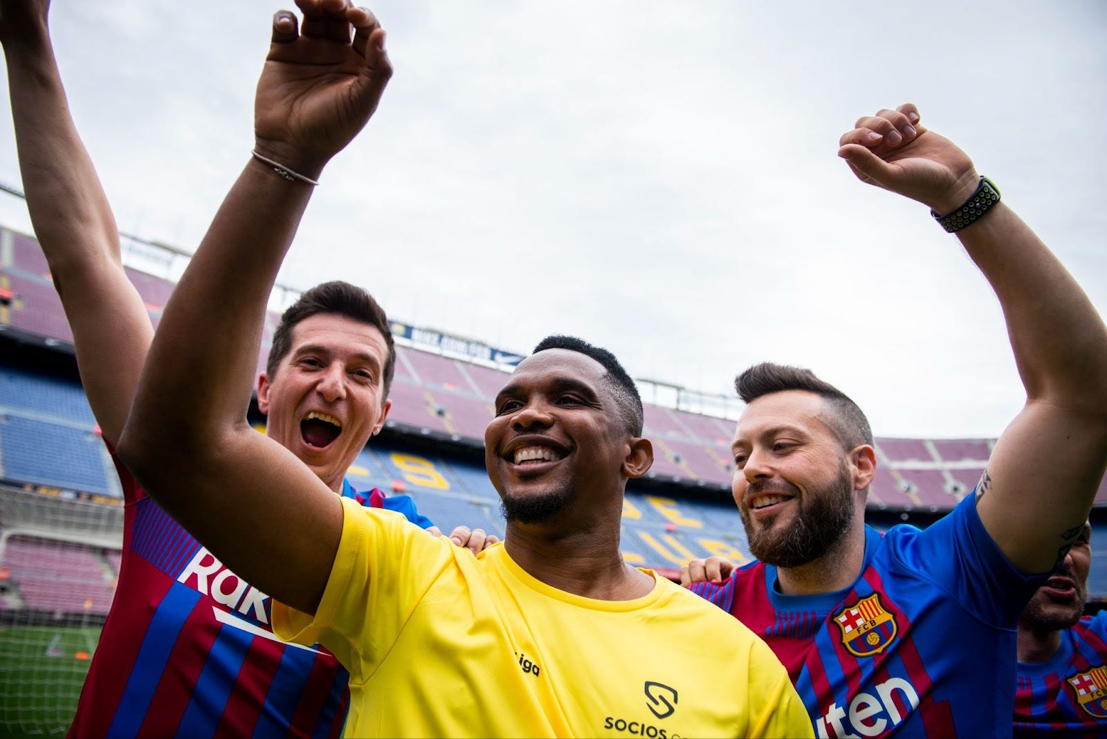 Dynamic Manchester City FC players on pitch with overlaid CITY fan token graphics, cheering fans in stadium, and Socios.com app interface displaying exclusive rewards