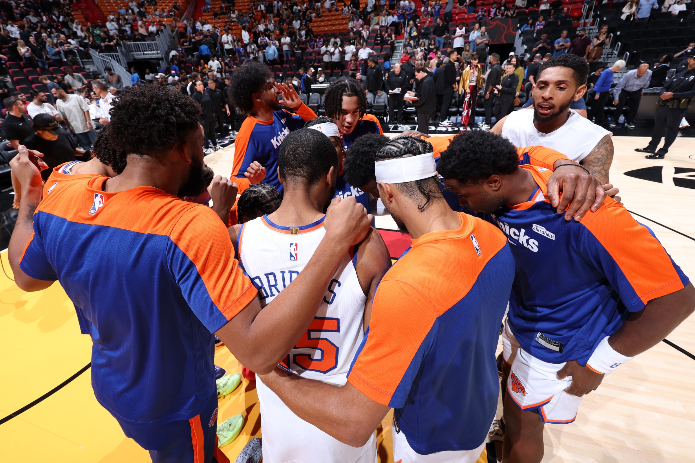 Fans celebrating in a stadium holding digital collectibles and NFTs, showcasing on-chain sports fandom and ownership with SCOR Protocol.