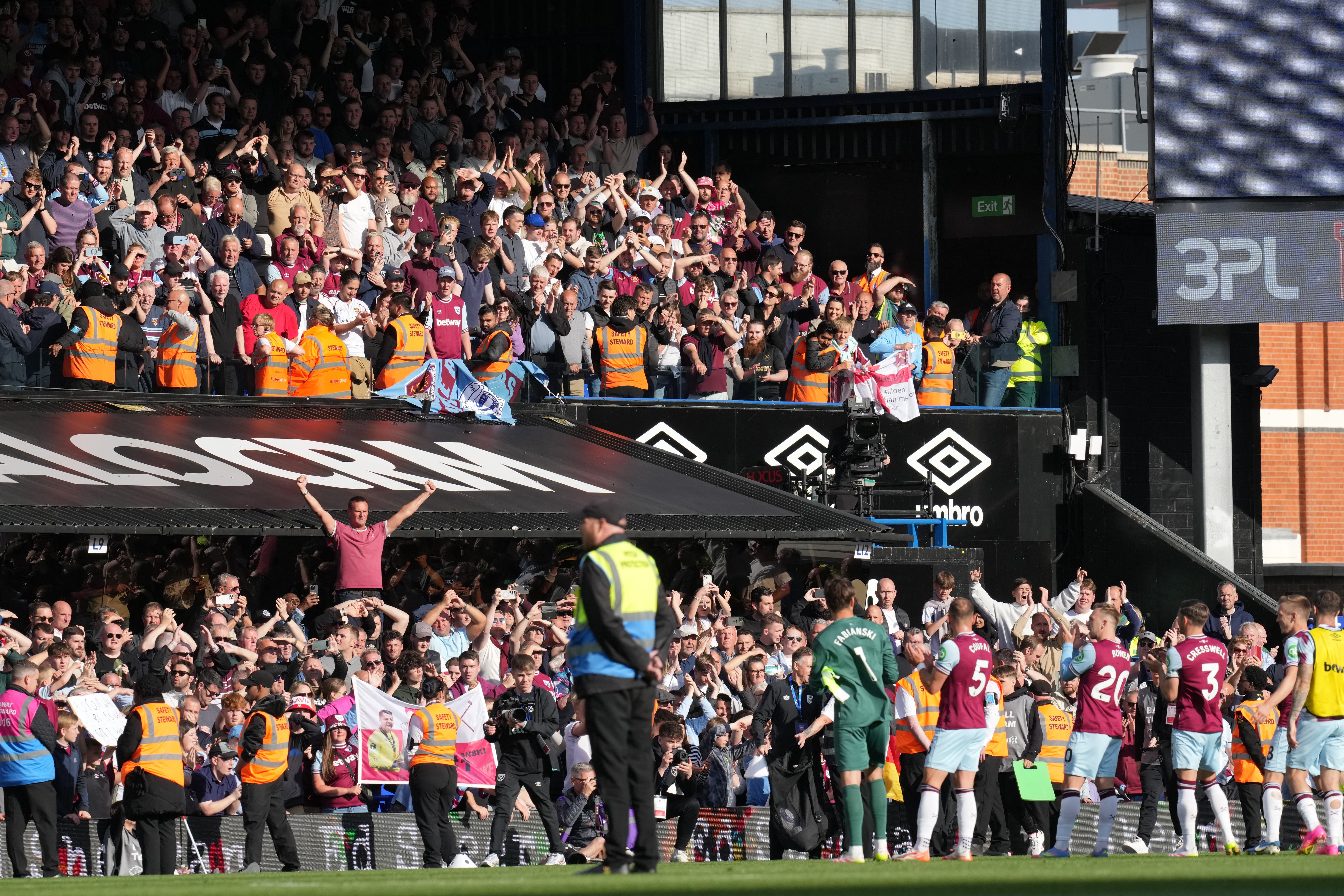 Soccer fans celebrating in a stadium, waving team scarves and showing unity, representing the community aspect of fan tokens