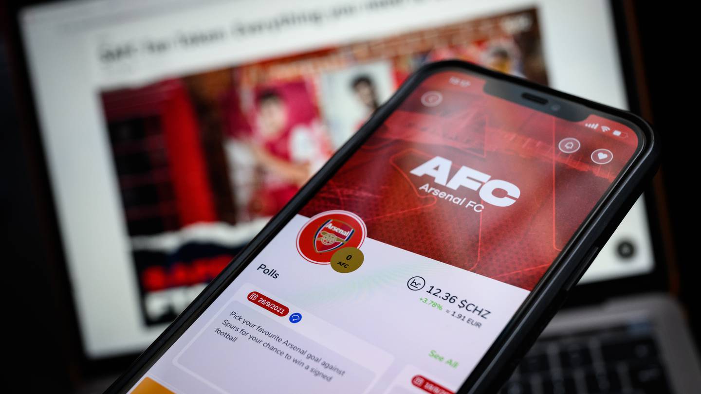 Fans using smartphones to vote in a Chiliz-powered club poll, showcasing blockchain-based fan engagement in sports