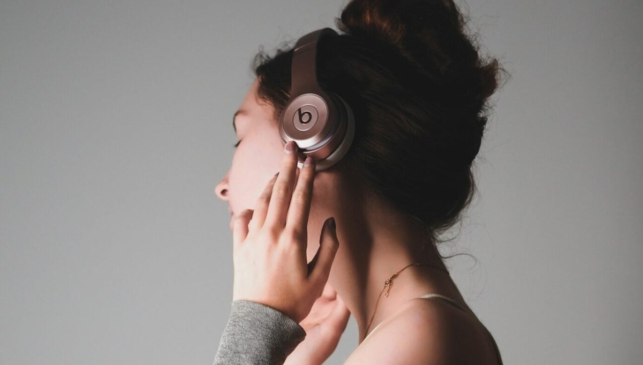 Frustrated indie musician at laptop reviewing low streaming royalty statements, evoking payout struggles in music industry