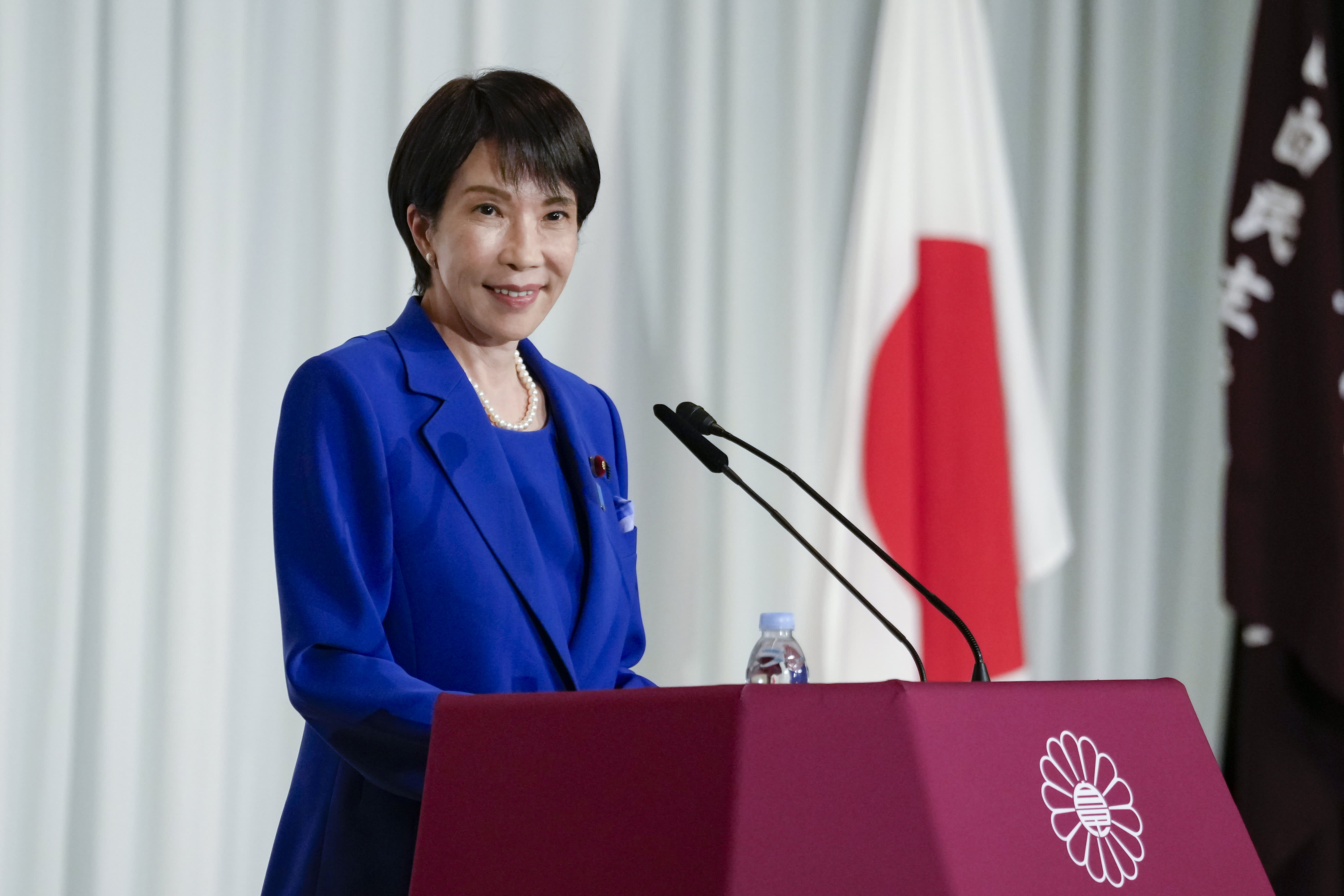 Japan Prime Minister Sanae Takaichi with Binance and PayPay logos representing crypto innovation and partnership in Japan