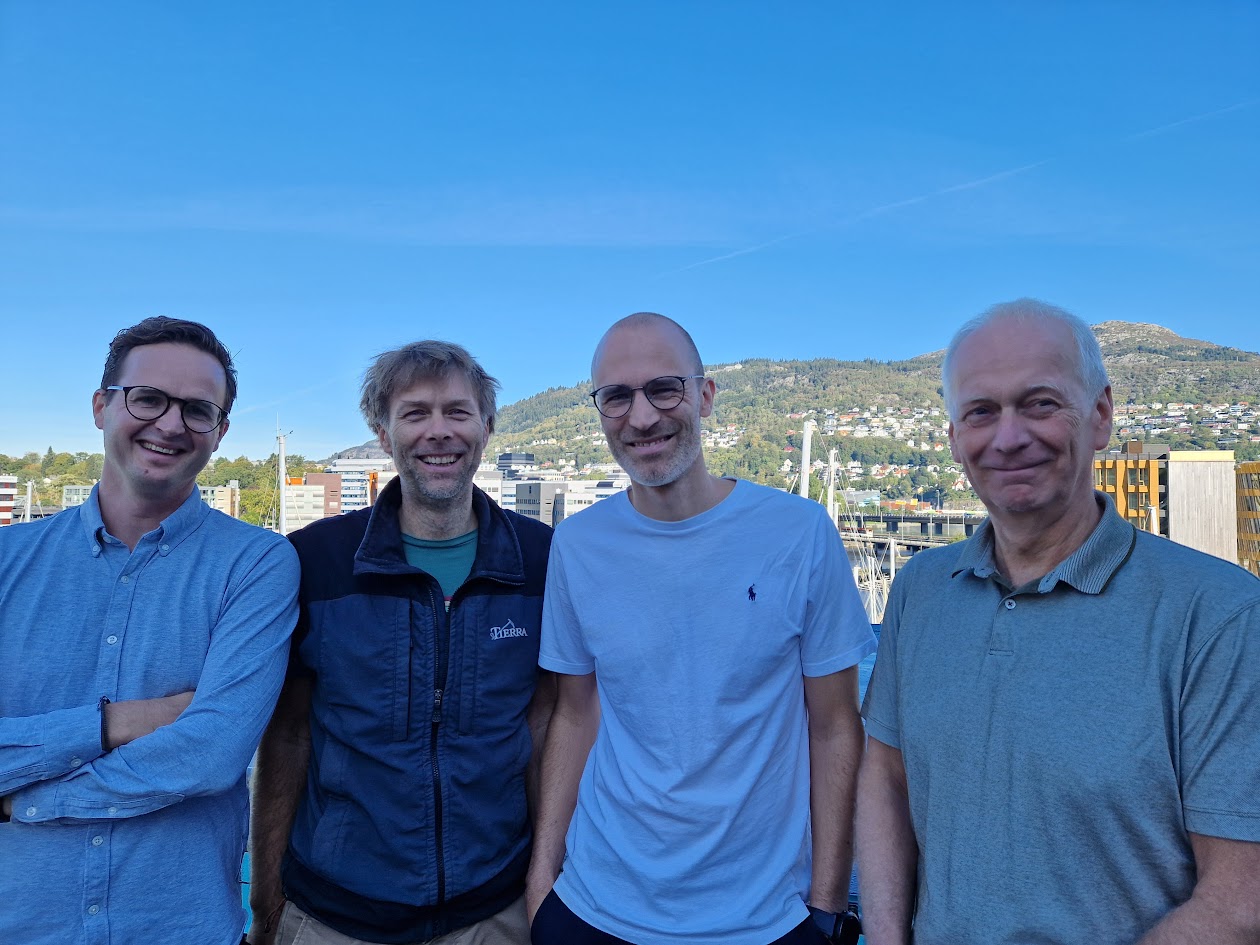 Modern office team collaborating while reviewing a crypto banking dashboard featuring Mercury, Revolut Business, Kraken Bank, and Juno for business accounts in 2024.