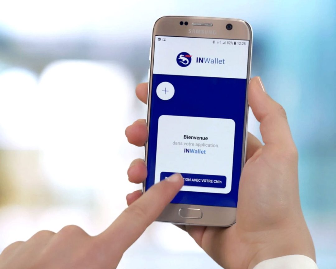 Person holding smartphone displaying a decentralized self-sovereign identity wallet interface
