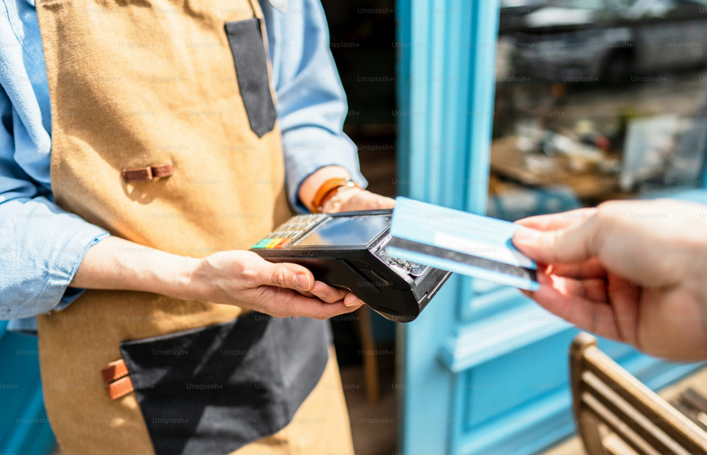 Person using a stablecoin card to pay at a café counter, illustrating modern crypto payment adoption in 2024