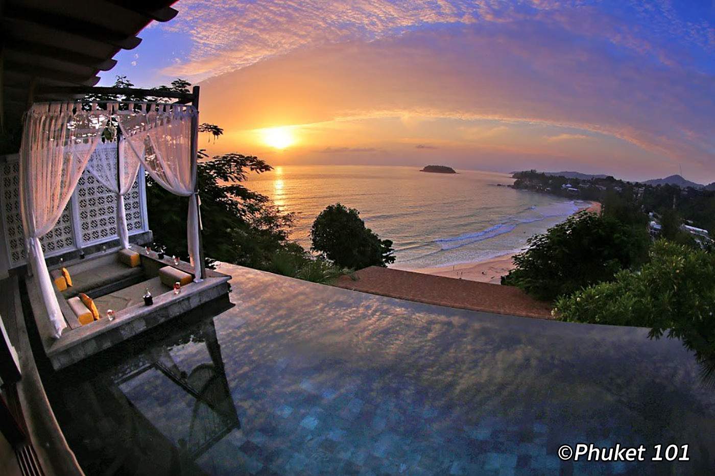 Serene beachfront hotel in Phuket Thailand with infinity pool and ocean sunset, ideal for crypto travelers booking seamless USDC zero-markup hotel stays