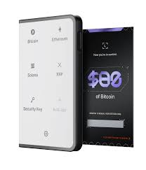 Side-by-side photo of Ledger Stax, Ledger Flex, and Ledger Nano S Plus hardware wallets on a desk for comparison in 2024