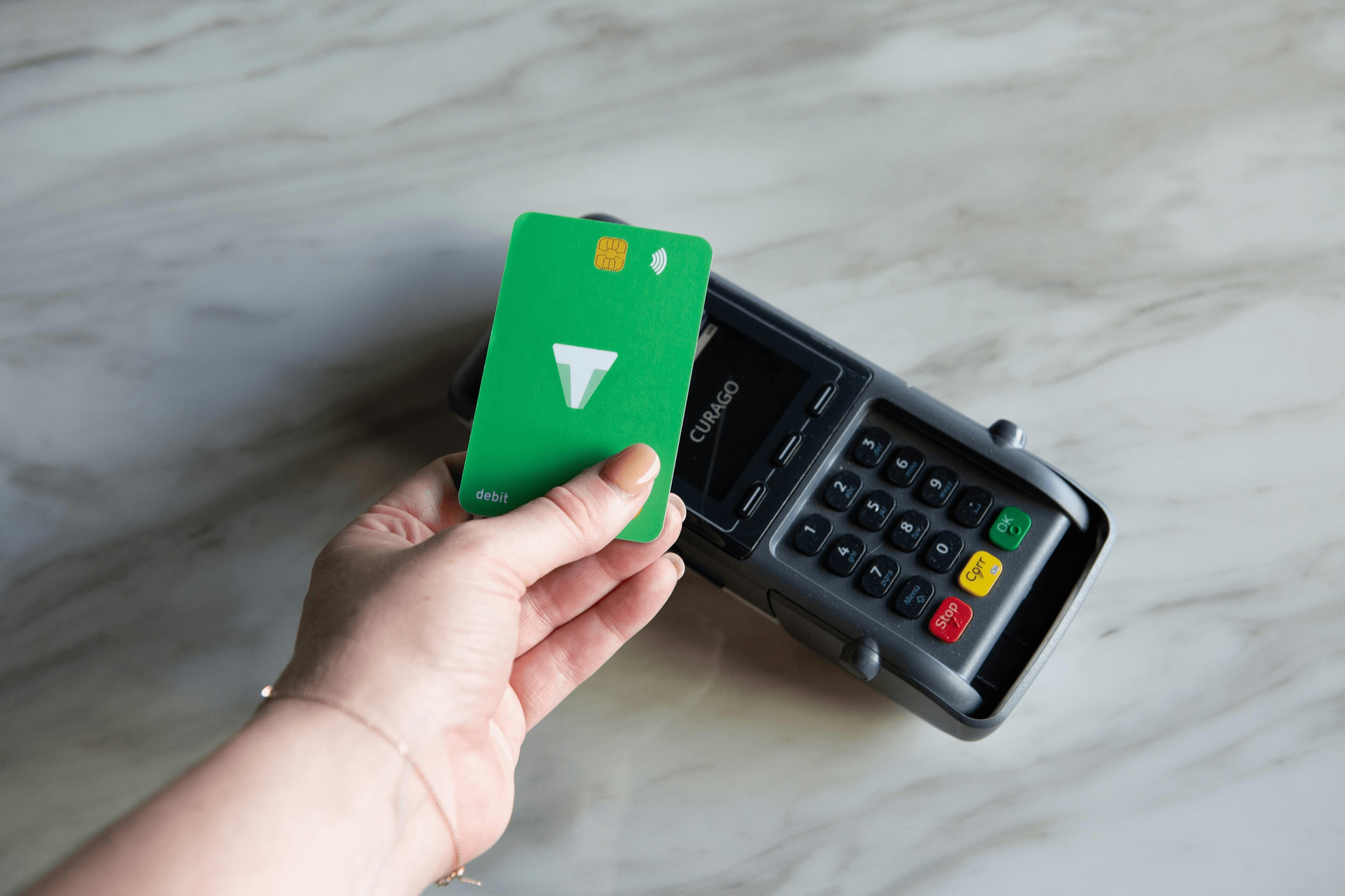 Sleek private stablecoin Visa debit card swiped at POS terminal for anonymous crypto-to-fiat spending, emphasizing privacy, no-KYC global acceptance for COCA, PlasBit, Uquid cards