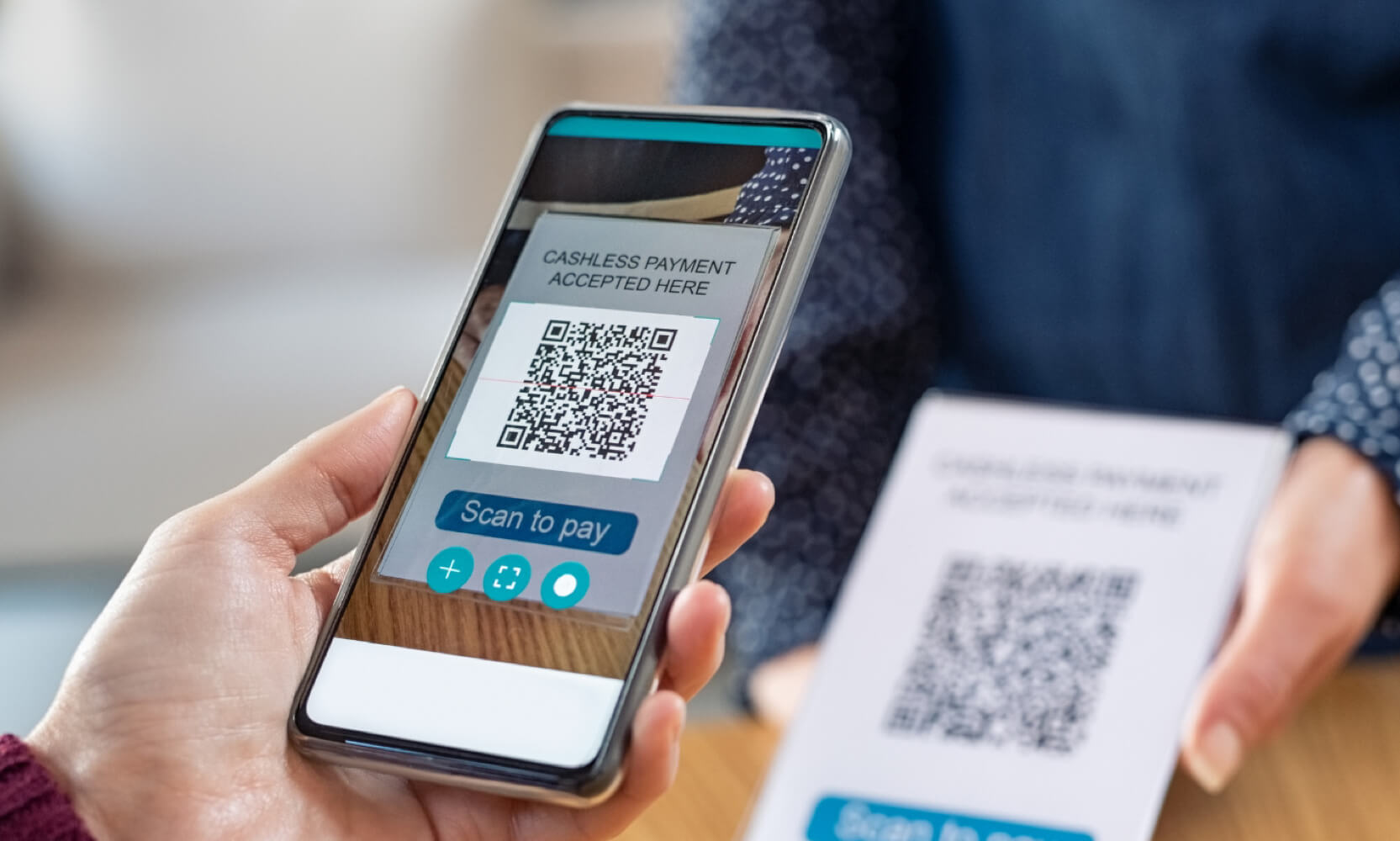Street vendor displaying custom USDT QR code on portable POS terminal for offline cryptocurrency payments in bustling market
