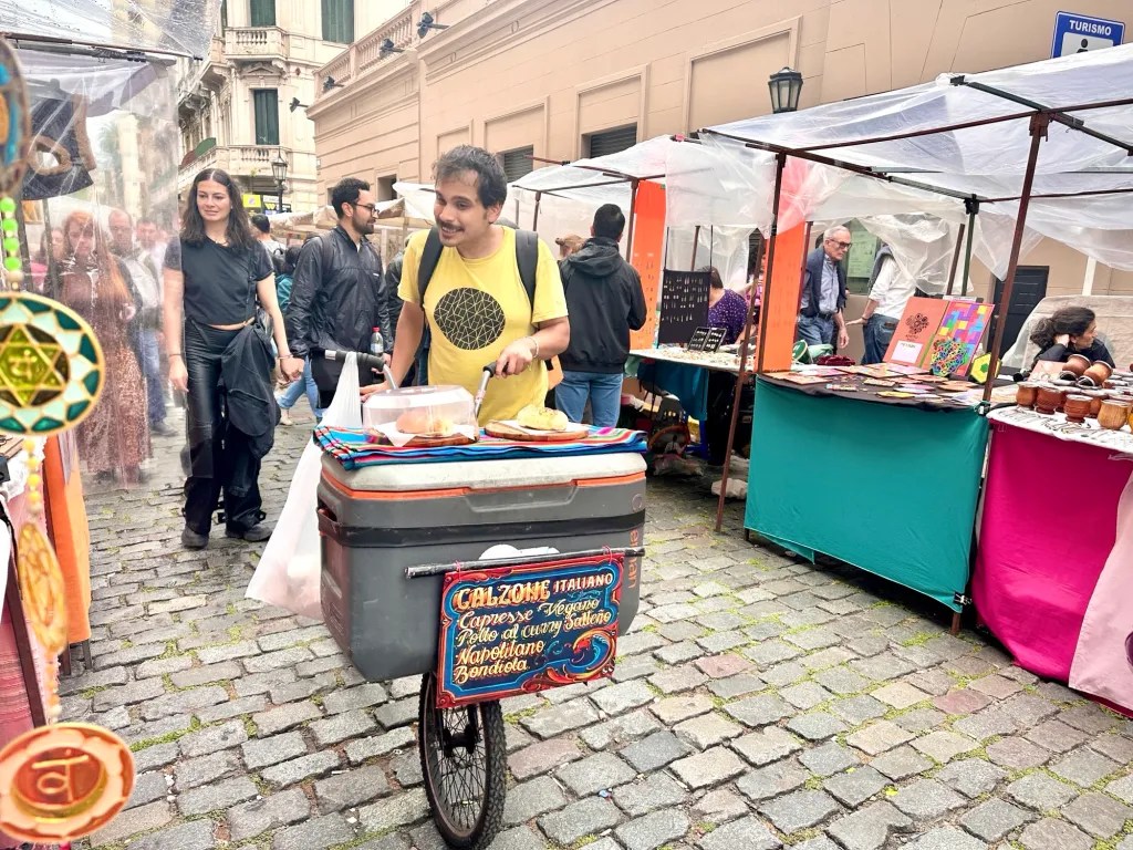 Street vendor in Buenos Aires market displaying StableQRPay USDC QR code on cart for offline stablecoin payments, enabling crypto transactions without internet