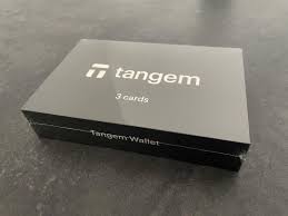 Tangem hardware wallet cards fanned out on a wooden table, showcasing their sleek and compact design for cryptocurrency storage